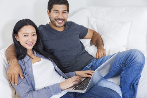 Asian Chinese Couple Using Laptop at Home